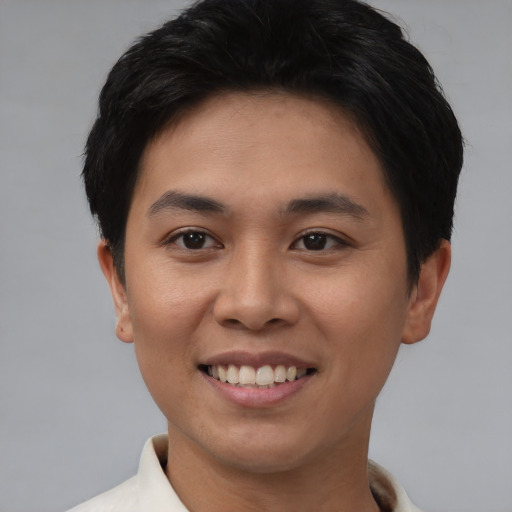 Joyful asian young-adult female with short  black hair and brown eyes