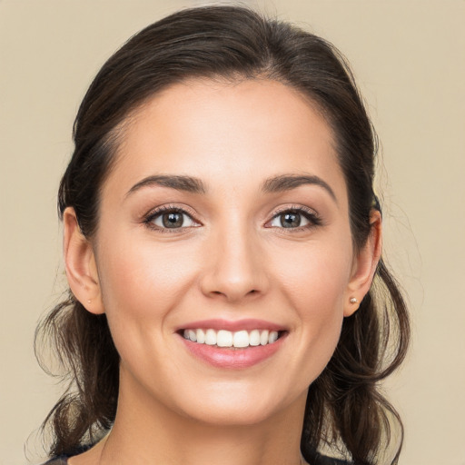 Joyful white young-adult female with medium  brown hair and brown eyes