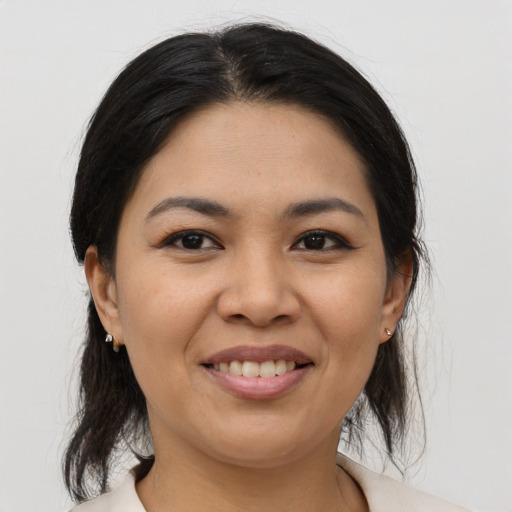 Joyful asian young-adult female with medium  brown hair and brown eyes