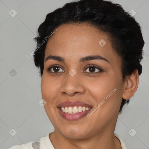 Joyful latino young-adult female with short  black hair and brown eyes