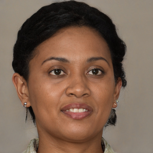 Joyful black adult female with medium  brown hair and brown eyes
