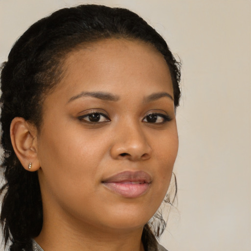 Joyful black young-adult female with long  brown hair and brown eyes