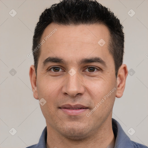 Joyful white young-adult male with short  black hair and brown eyes