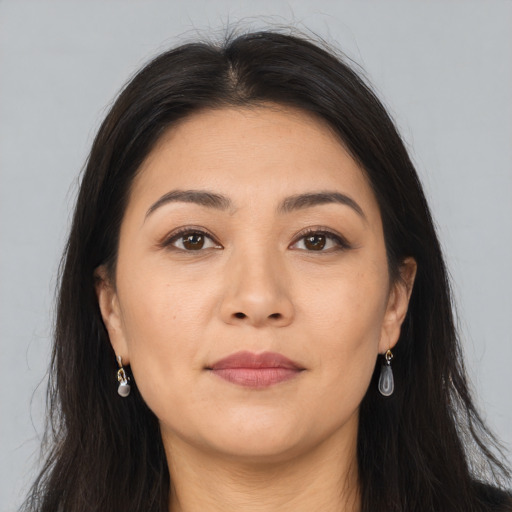 Joyful asian young-adult female with long  brown hair and brown eyes