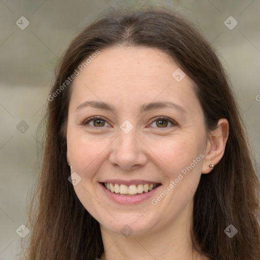 Joyful white adult female with long  brown hair and grey eyes