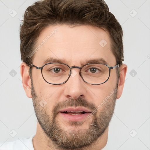 Joyful white adult male with short  brown hair and grey eyes