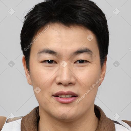 Joyful asian young-adult male with short  black hair and brown eyes