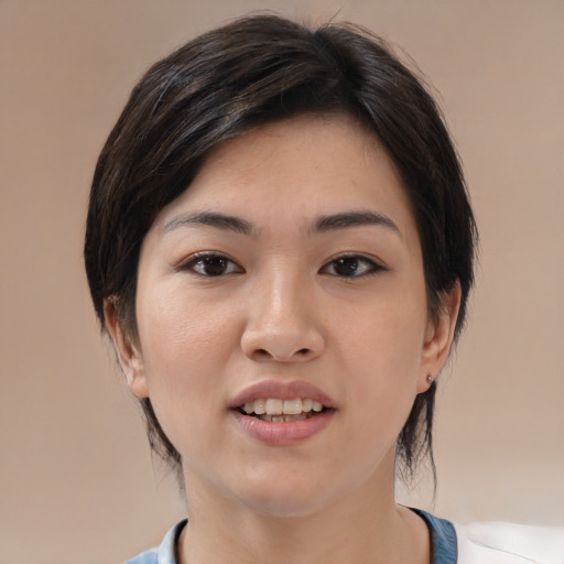 Joyful white young-adult female with medium  black hair and brown eyes