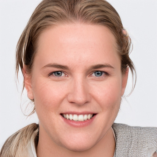 Joyful white young-adult female with medium  brown hair and blue eyes