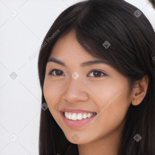 Joyful latino young-adult female with long  brown hair and brown eyes