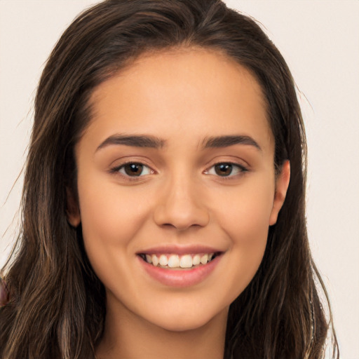 Joyful white young-adult female with long  brown hair and brown eyes