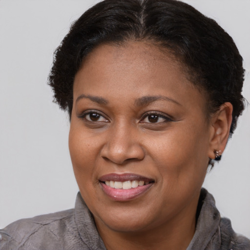Joyful latino adult female with short  brown hair and brown eyes