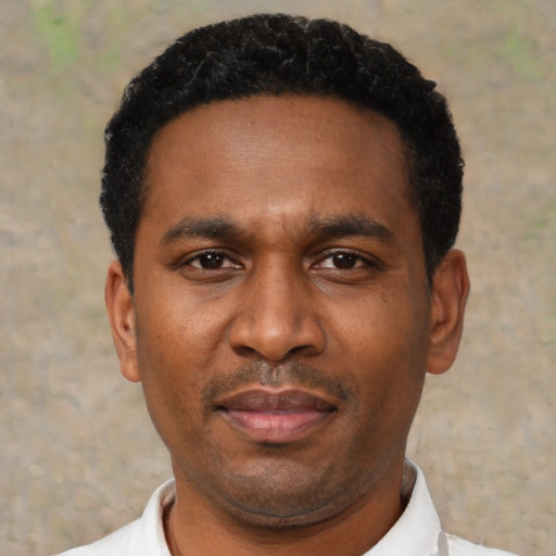 Neutral latino adult male with short  black hair and brown eyes