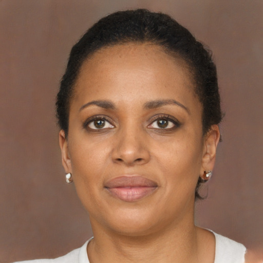 Joyful black young-adult female with short  brown hair and brown eyes