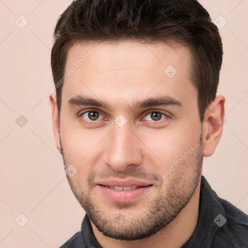 Joyful white young-adult male with short  brown hair and brown eyes