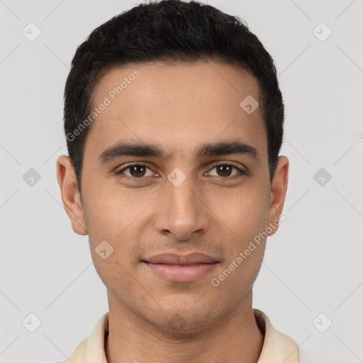 Joyful latino young-adult male with short  brown hair and brown eyes