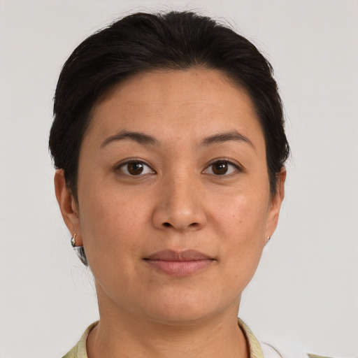 Joyful asian adult female with short  brown hair and brown eyes