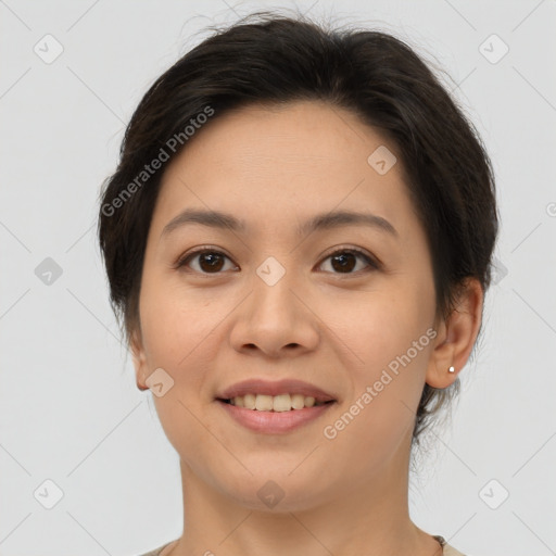 Joyful asian young-adult female with short  brown hair and brown eyes