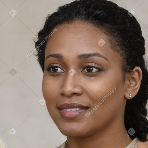 Joyful black young-adult female with medium  black hair and brown eyes