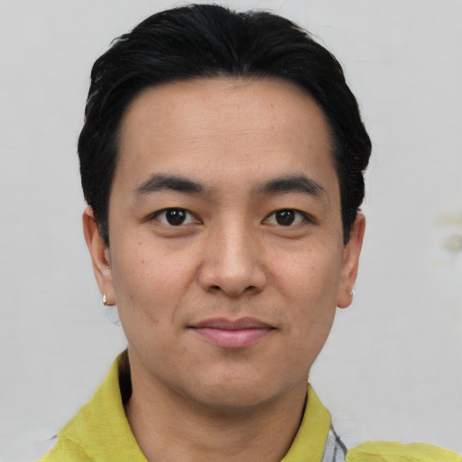 Joyful asian young-adult male with short  black hair and brown eyes
