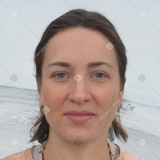 Joyful white adult female with medium  brown hair and brown eyes