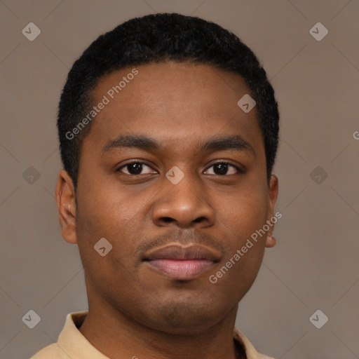 Joyful black young-adult male with short  brown hair and brown eyes