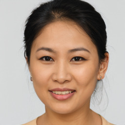 Joyful asian young-adult female with medium  brown hair and brown eyes