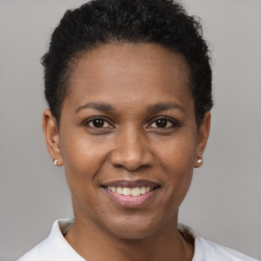 Joyful black young-adult female with short  brown hair and brown eyes
