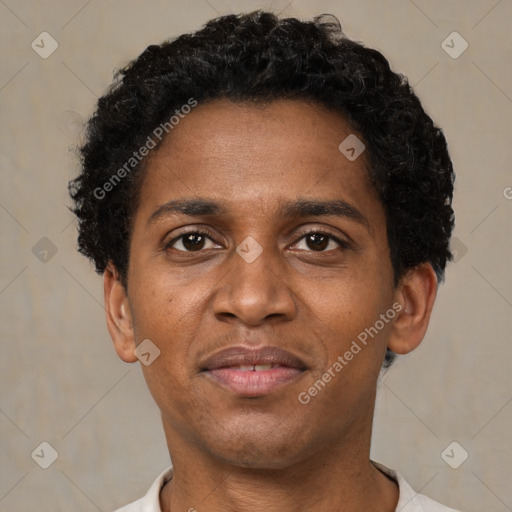 Joyful black adult male with short  brown hair and brown eyes