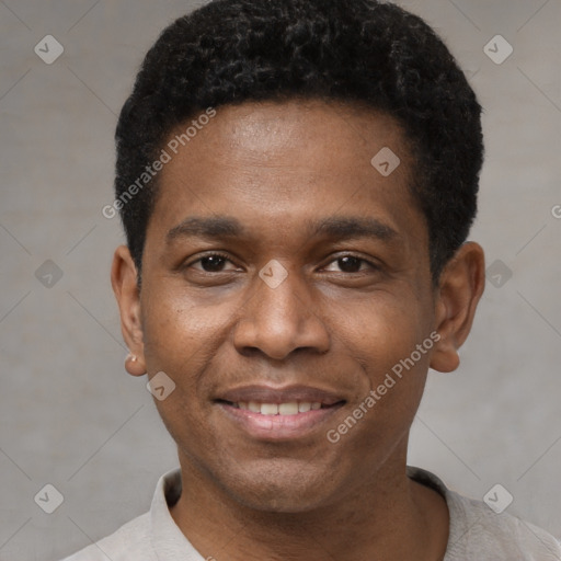 Joyful black young-adult male with short  black hair and brown eyes