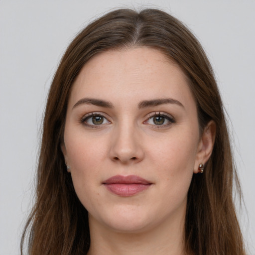 Joyful white young-adult female with long  brown hair and green eyes