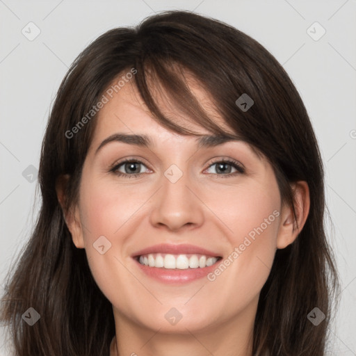 Joyful white young-adult female with long  brown hair and grey eyes