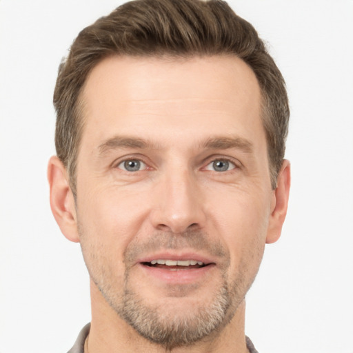 Joyful white adult male with short  brown hair and grey eyes