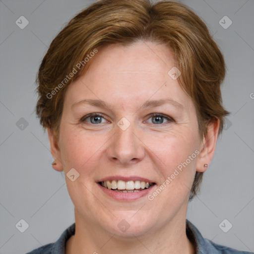 Joyful white adult female with medium  brown hair and blue eyes