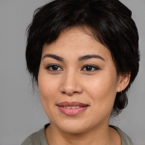 Joyful asian young-adult female with medium  brown hair and brown eyes