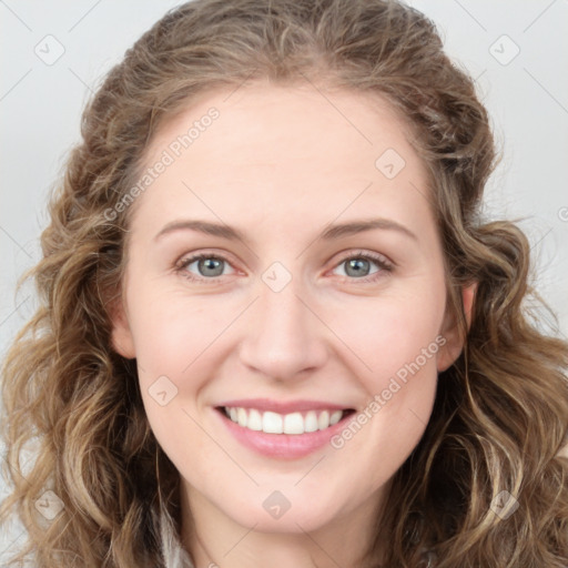 Joyful white young-adult female with long  brown hair and green eyes