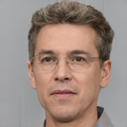 Joyful white middle-aged male with short  brown hair and brown eyes