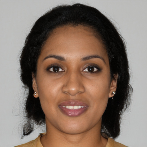 Joyful black young-adult female with medium  brown hair and brown eyes