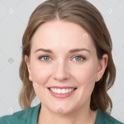 Joyful white young-adult female with medium  brown hair and blue eyes