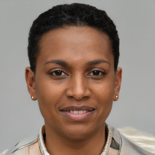 Joyful black young-adult female with short  brown hair and brown eyes