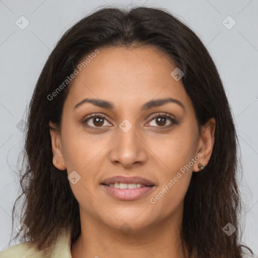 Joyful latino young-adult female with long  brown hair and brown eyes