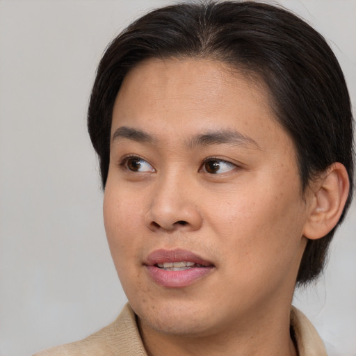 Joyful asian young-adult female with short  brown hair and brown eyes