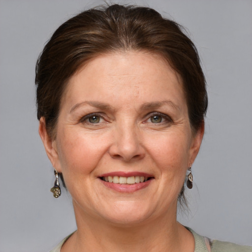 Joyful white adult female with medium  brown hair and grey eyes