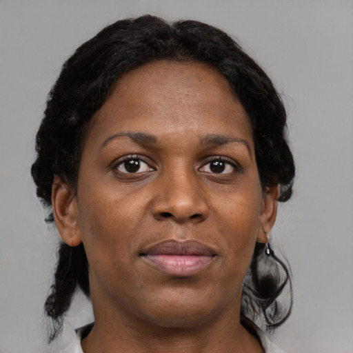 Joyful black young-adult female with medium  black hair and brown eyes