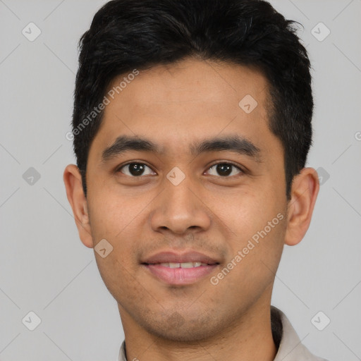 Joyful latino young-adult male with short  black hair and brown eyes