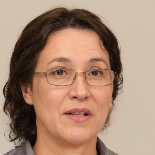 Joyful white middle-aged female with medium  brown hair and brown eyes