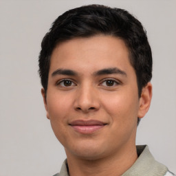 Joyful latino young-adult male with short  black hair and brown eyes