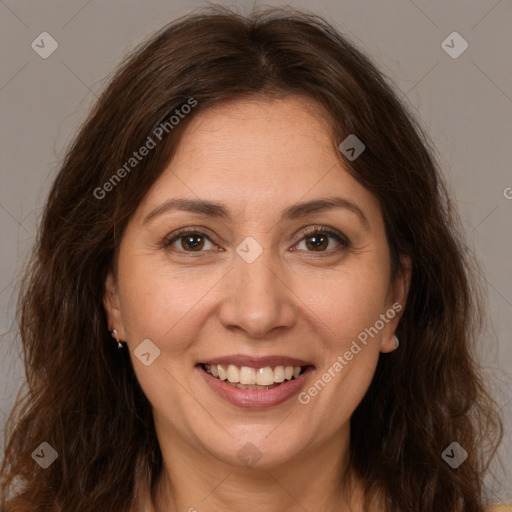 Joyful white adult female with long  brown hair and brown eyes