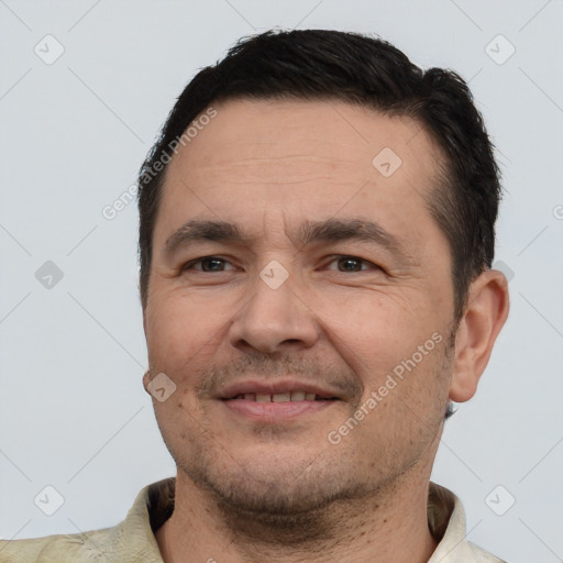 Joyful white adult male with short  brown hair and brown eyes