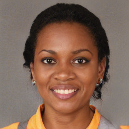 Joyful black young-adult female with short  black hair and brown eyes